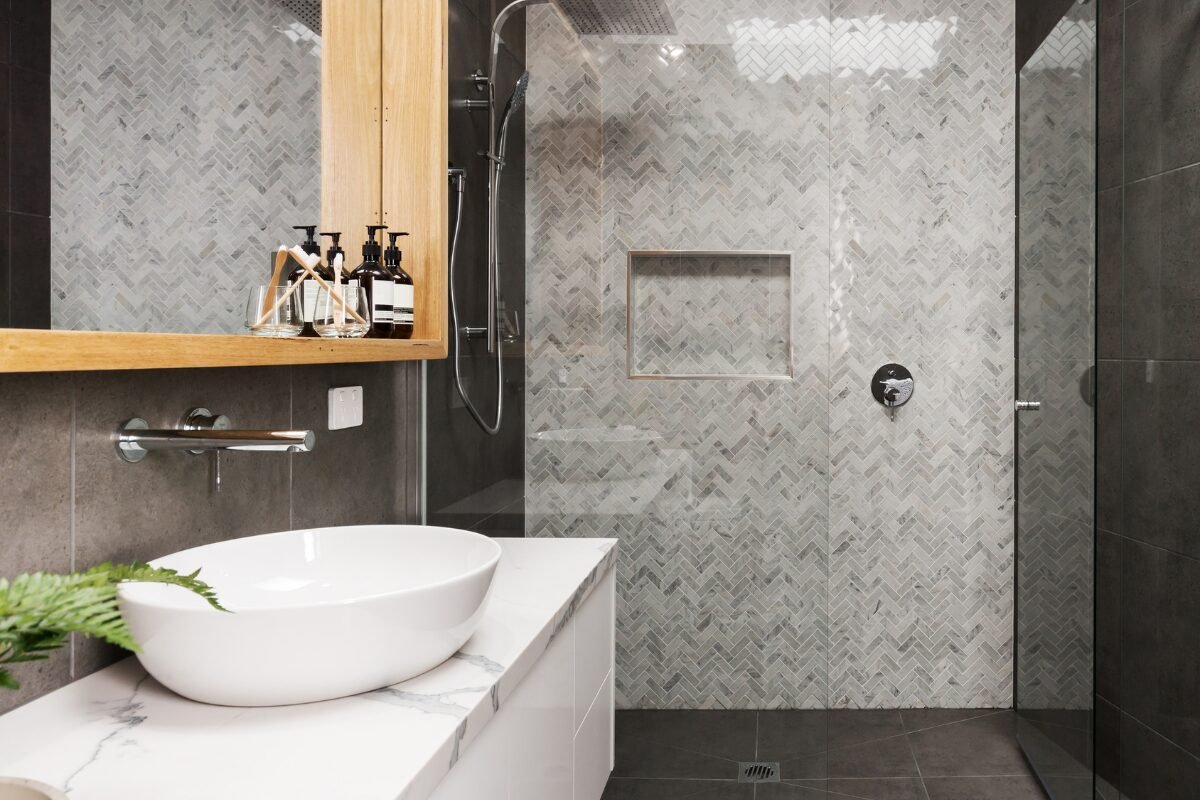 Beautifully tiled shower in Mint Hill, NC with black accent tile on the shower floor.